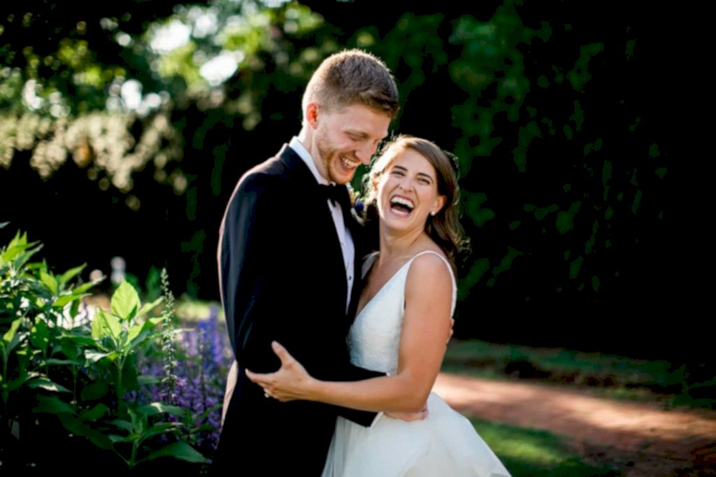 A couple laughs in the gardens at James Monroe's Highland -- a garden wedding venue outside of Charlottesville 