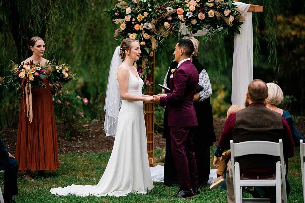 A couple stands at the altar during their micro wedding at Clyde Willow Creek Farm