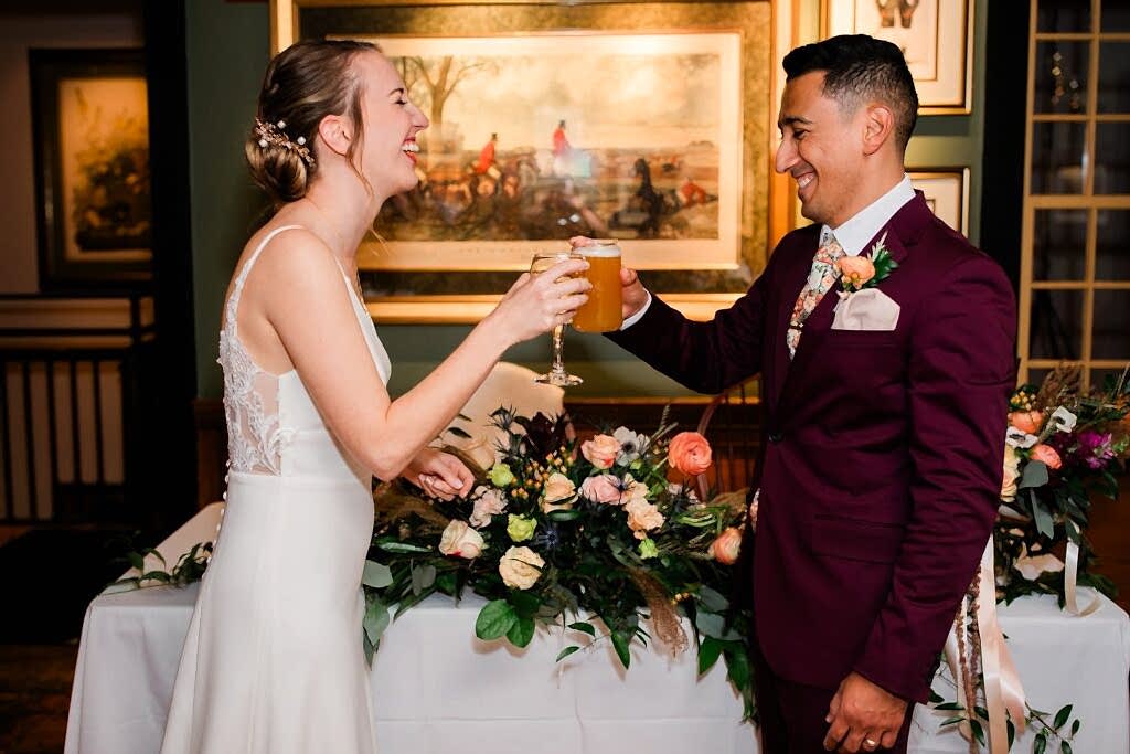 A couple shares a toast during their wedding reception at Clyde Willow Creek Farm