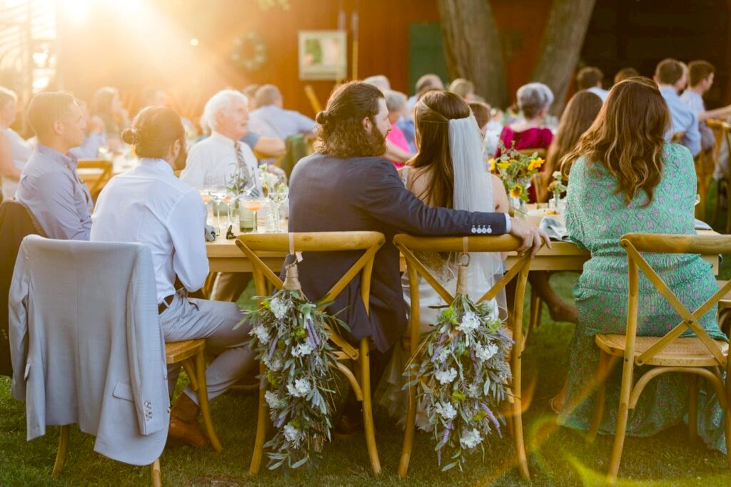 A couple sits during their reception at a backyard wedding in Virginia 